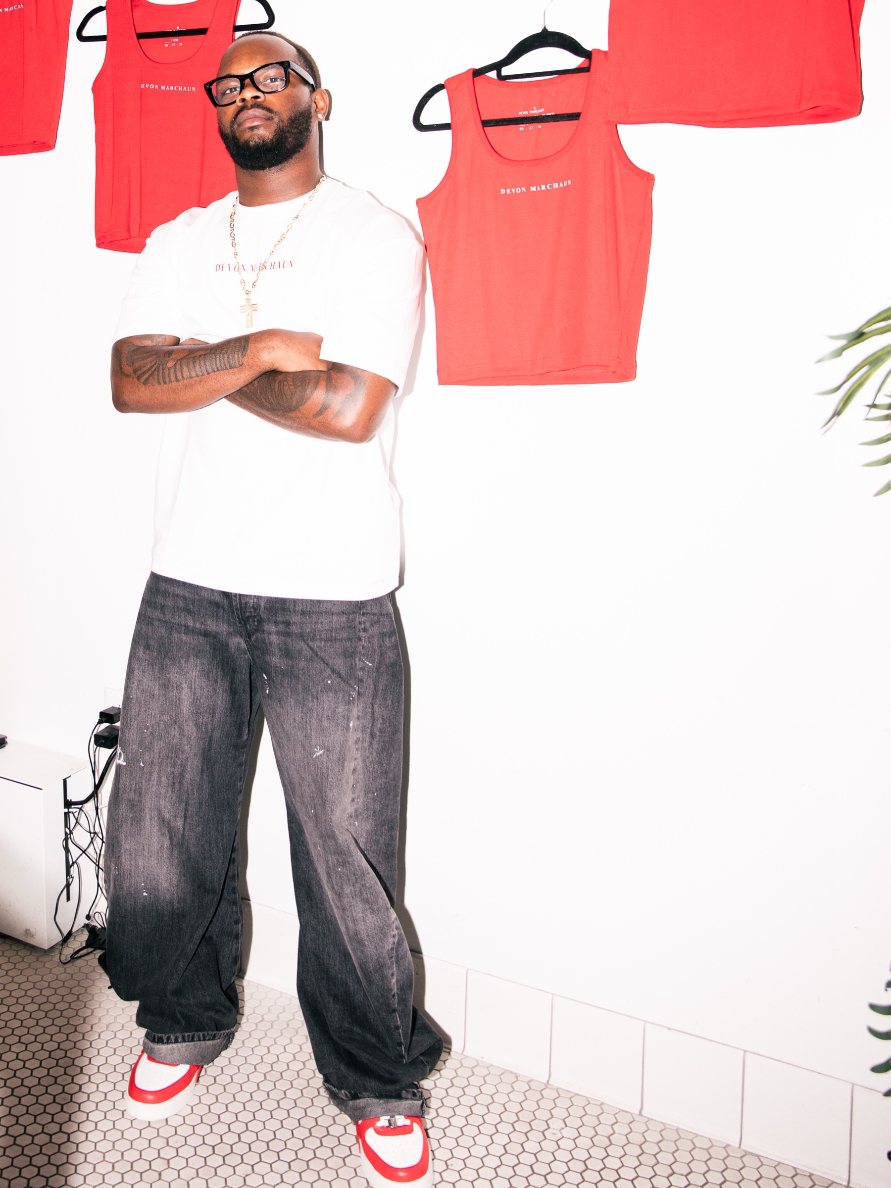 Devon Marchaun standing with the red Chapter 01 ROJA pieces